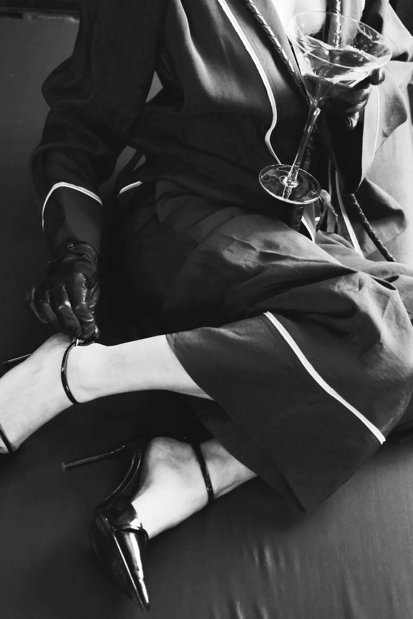 close up of Aidos Akida pumps, leather glove and martini glass