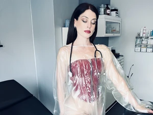 Aido Akida, wearing red latex corset, black latex gloves and latex medical coat