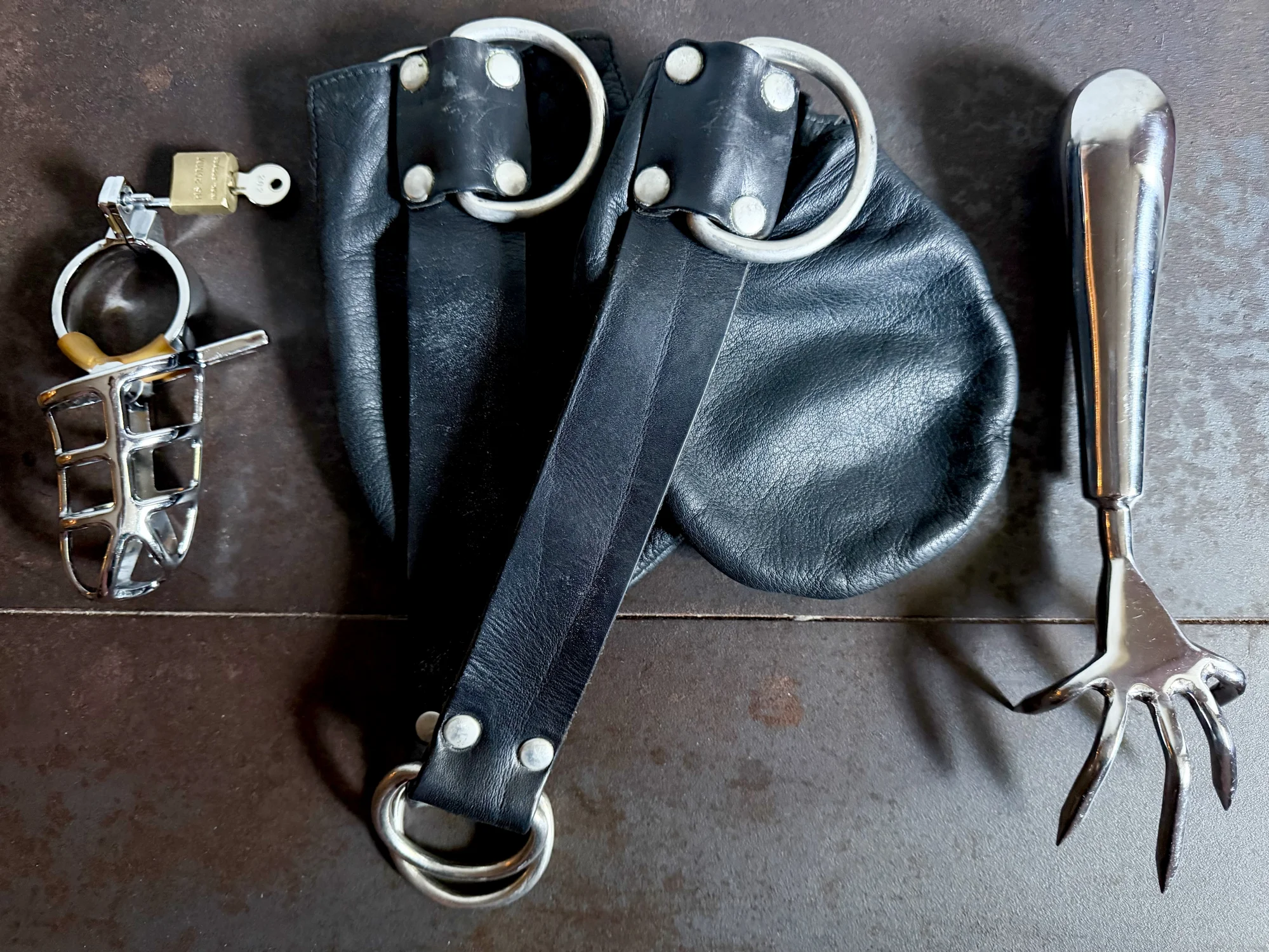 Close up of BDSM gear and chastity cage