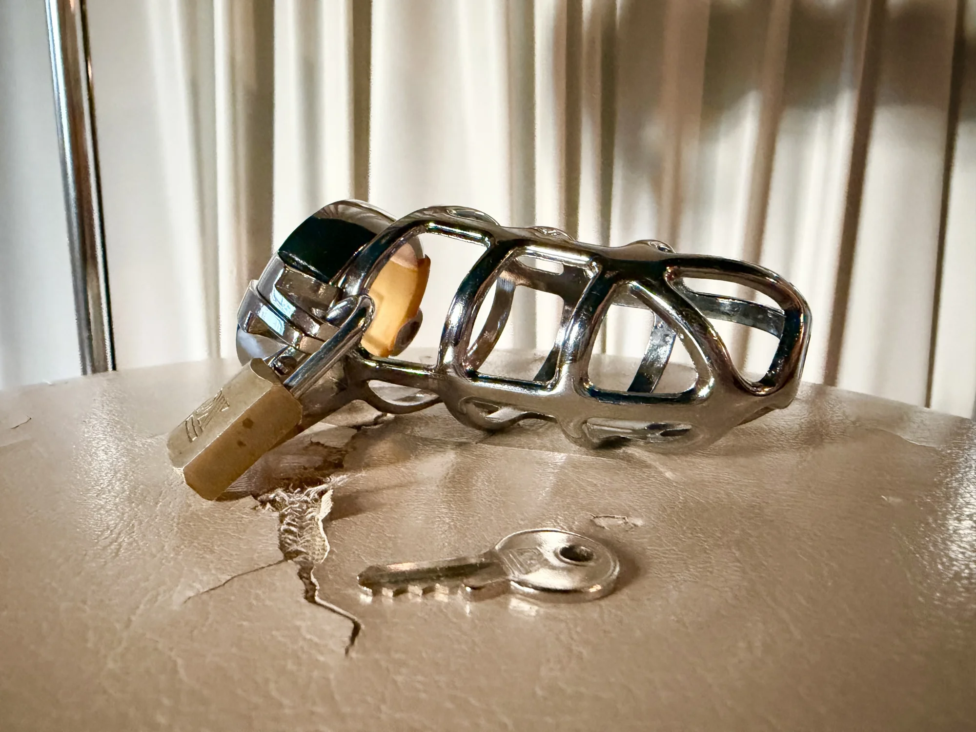 Close up picure of a chastity device, white background