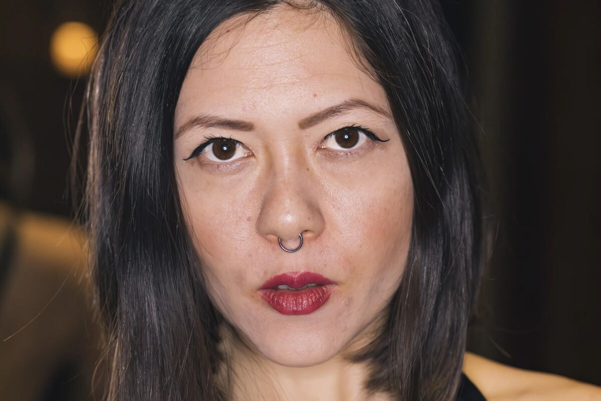 Professional dominatrix Anki Slay in Berlin, looking with a commanding, seductive gaze