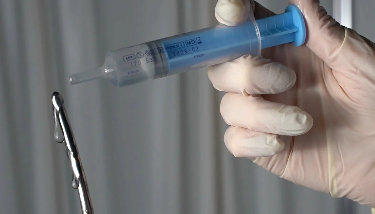 medical glove holds sterile lubricant injector