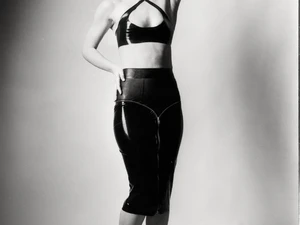 Miss Flora poses in latex skirt and top and high heels for black and white photography in Berlin