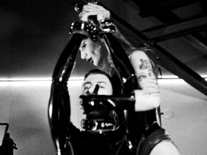 Miss Vera Violette dominating tied up latex submissive.